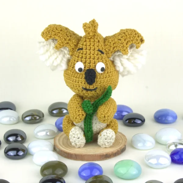 Mofli Koala Crochet Amigurumi next to pearl stones