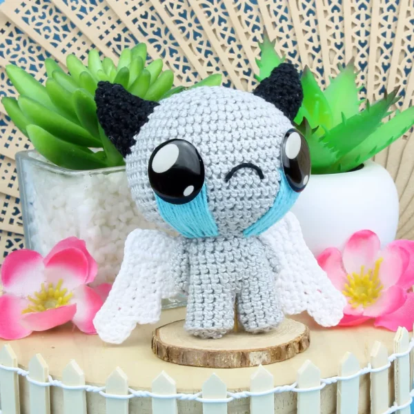 Binding of Isaac Apollyon Crochet Amigurumi surrounded by plants and flowers