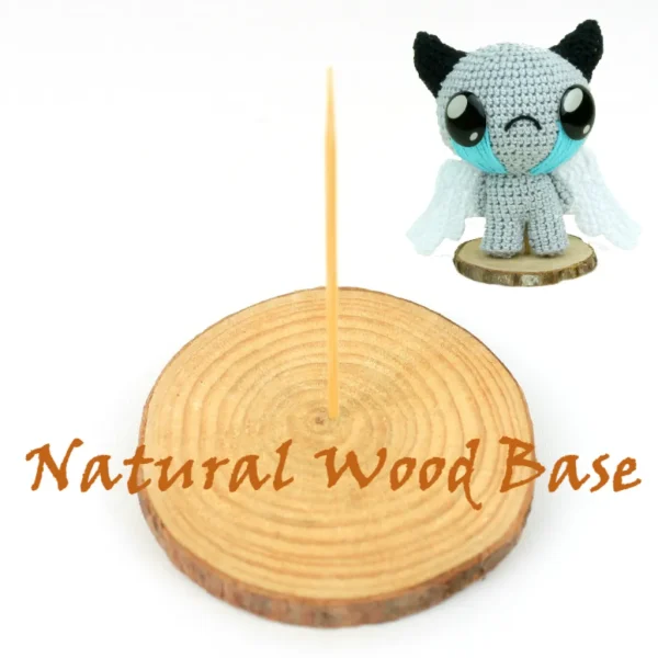 Binding of Isaac Apollyon Crochet Amigurumi and natural wooden base over white background