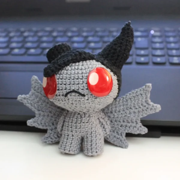 The Binding of Isaac Azazel Crochet Amigurumi in front of gaming keyboard