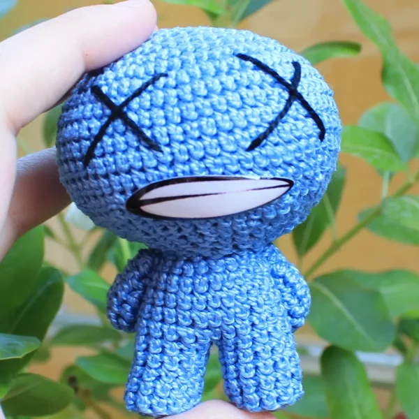 Binding of Isaac Blue Baby Crochet Amigurumi close up shot on holding hand