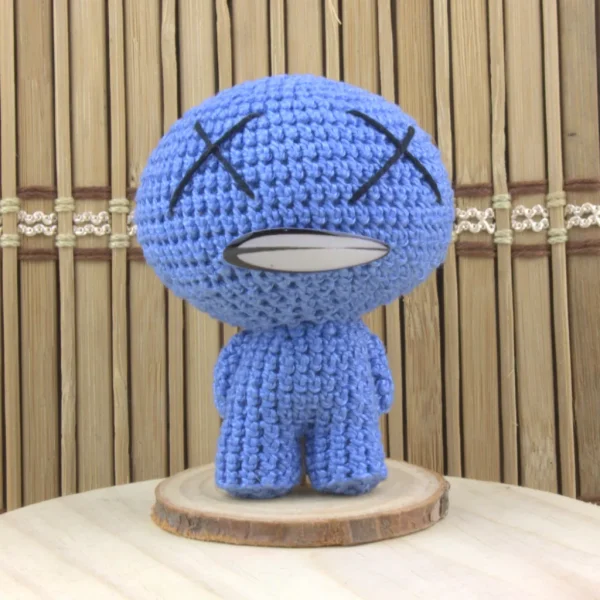 Binding of Isaac Blue Baby Crochet Amigurumi over wood background