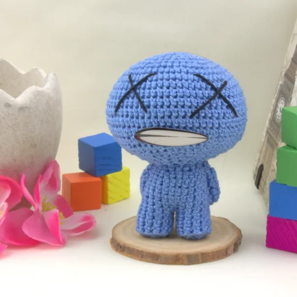 Binding of Isaac Blue Baby Crochet Amigurumi next to colorful cubes