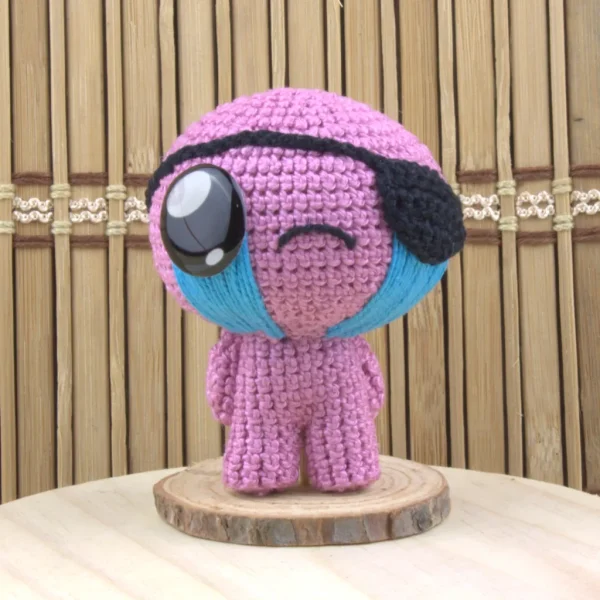 Binding of Isaac Cain Crochet Amigurumi over wooden background