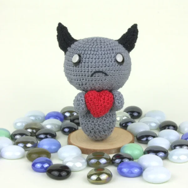 Binding of Isaac Dark Bum Crochet Amigurumi front view next to pearl stones