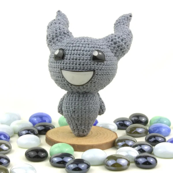 Binding of Isaac Lil Brimstone Crochet Amigurumi next to pearl stones