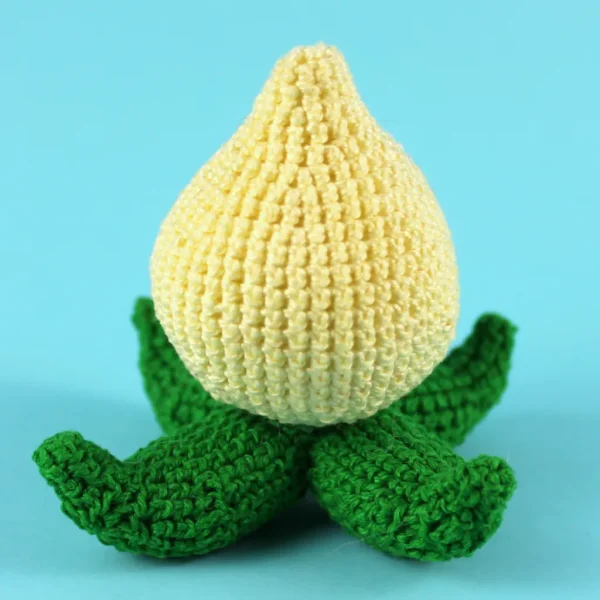 Yellow and Green Crochet Amigurumi Pachimari Back on Light Blue Background