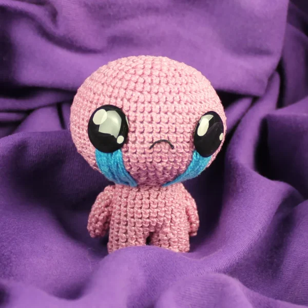 Pink Isaac Crochet Amigurumi on Purple Background