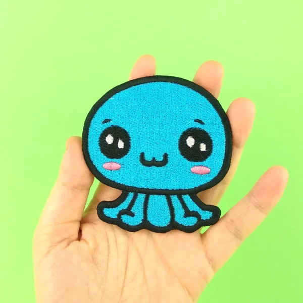 Medium Blue Kawaii Octopus Embroidered Patch on holding hand