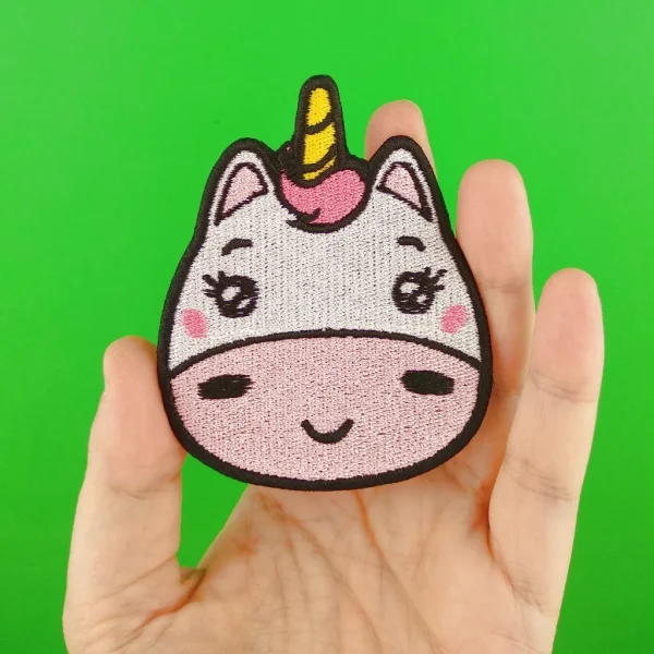 Medium White and Pink Kawaii Unicorn Embroidered Patch on holding hand