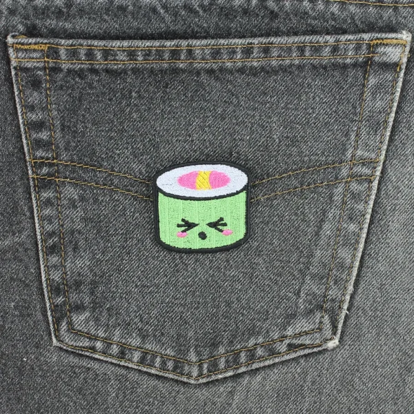 Green Kawaii Sushi Embroidered Patch on black jeans