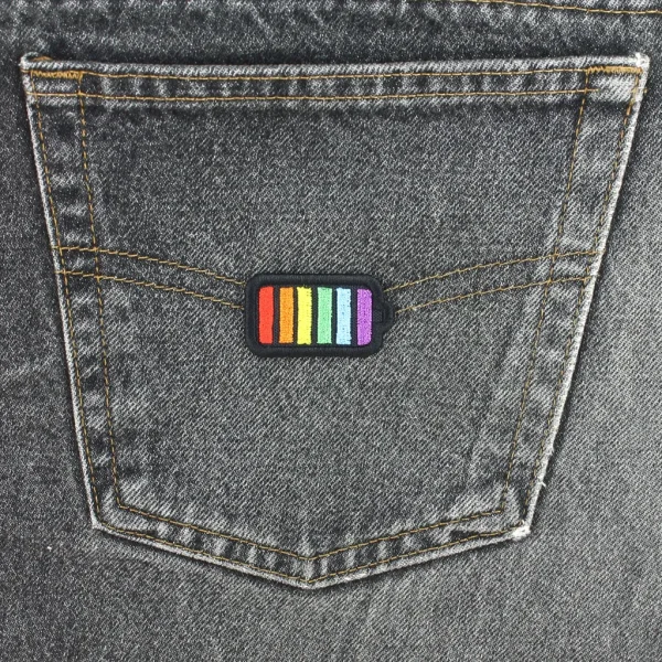 Rainbow Battery Embroidered Patch on black jeans