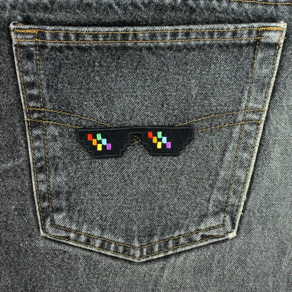 Rainbow Pixelated Glasses Embroidered Patch on black jeans