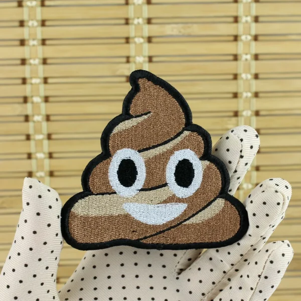 medium Smiling Cute Pile of Poo Embroidered Patch on holding hand