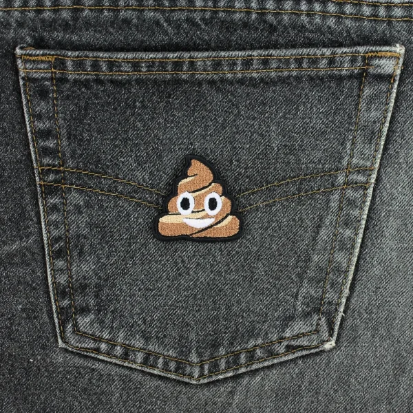 small Smiling Cute Pile of Poo Embroidered Patch on black jeans