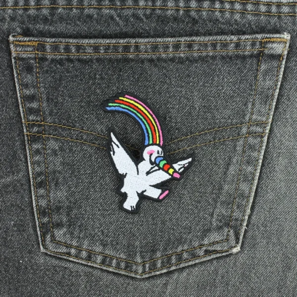 Rainbow Bird Embroidered Patch on black jeans