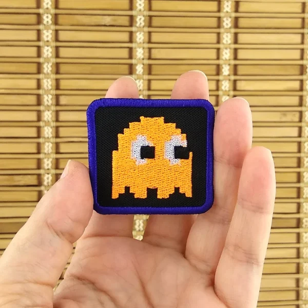 Orange Pixel Ghost Embroidered Patch on holding hand