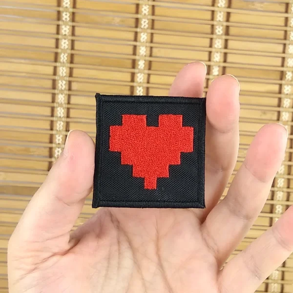 small Pixel Hearts Embroidered Patch on holding hand