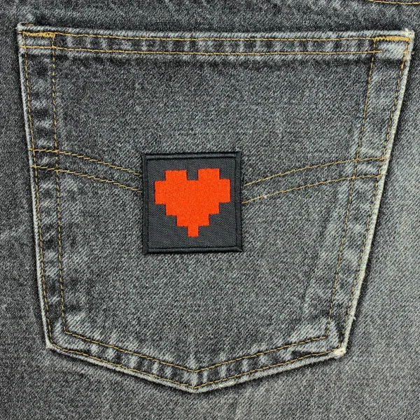 small Pixel Hearts Embroidered Patch on black jeans