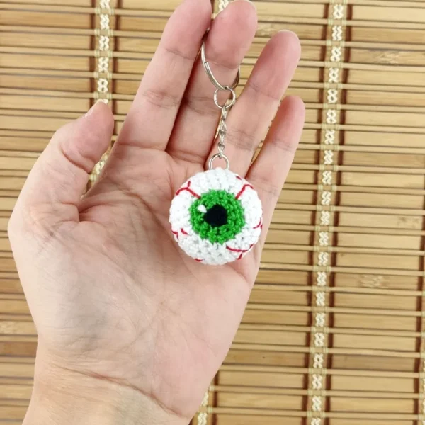 Green Creepy Eye Keychain on holding hand