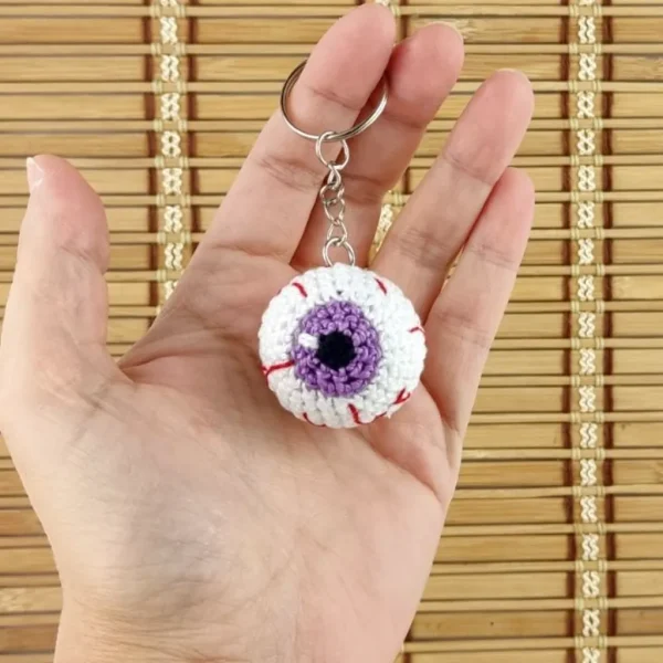 Purple Creepy Eye Keychain on holding hand