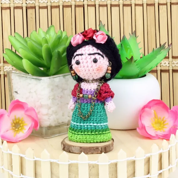 Mexican Doll Crochet Amigurumi next to decorative plants and flowers