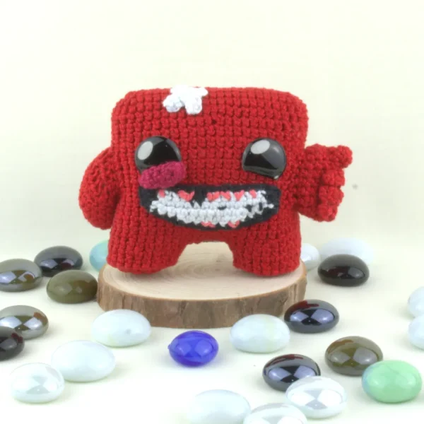 Super Meat Boy Crochet Amigurumi next to pearo stones