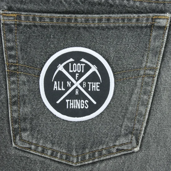 Loot All Things Embroidered Patch on black jeans