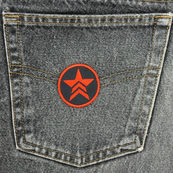 Small Renegade Logo Embroidered Patch on black jeans