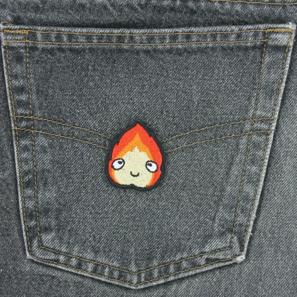 small Calcifer Anime Kawaii Fire Embroidered Patch on black jeans