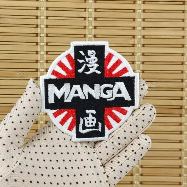 Manga Logo Embroidered Patch over white background on holding hand