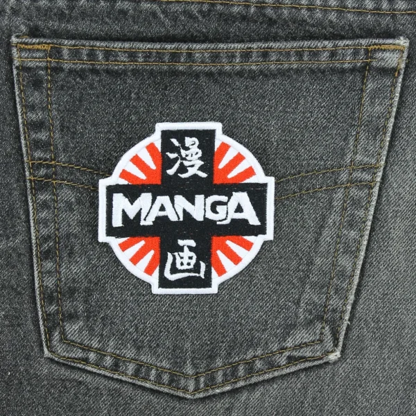 Manga Logo Embroidered Patch over white background on black jeans