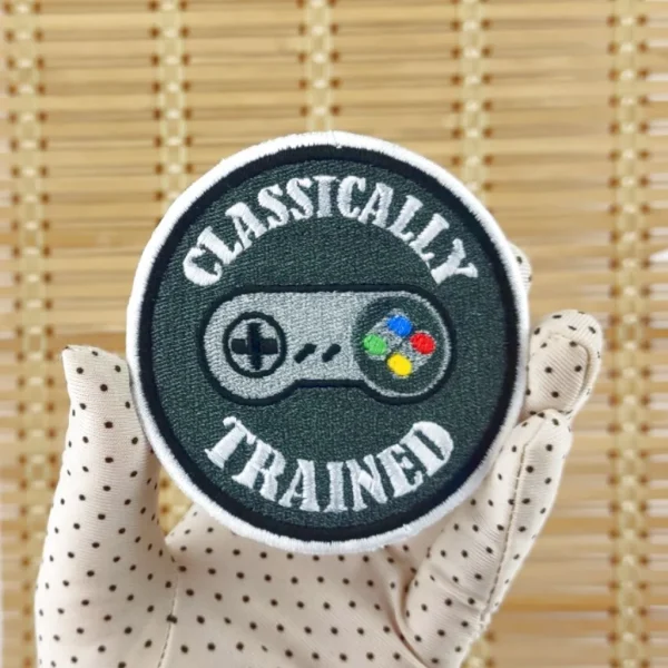 SNES controller Classically Trained 16-bits Embroidered Patch on holding hand