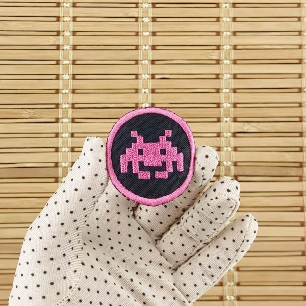 Space Invaders pink Pixel Alien Embroidered Patch on holding hand