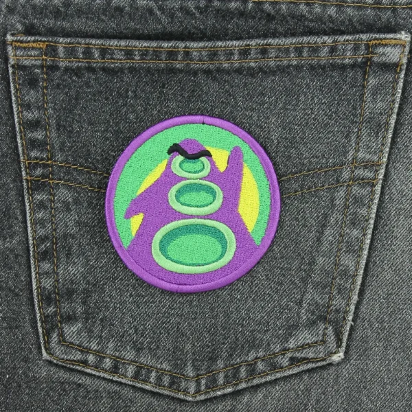 Day of the Tentacle Purple Tentacle Embroidered Patch on black jeans