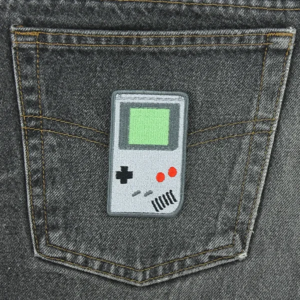 Grey Handheld Game Boy Console Embroidered Patch on black jeans