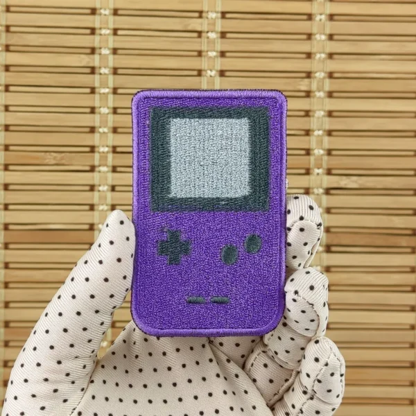 purple Handheld Game Boy Console Embroidered Patch on holding hand