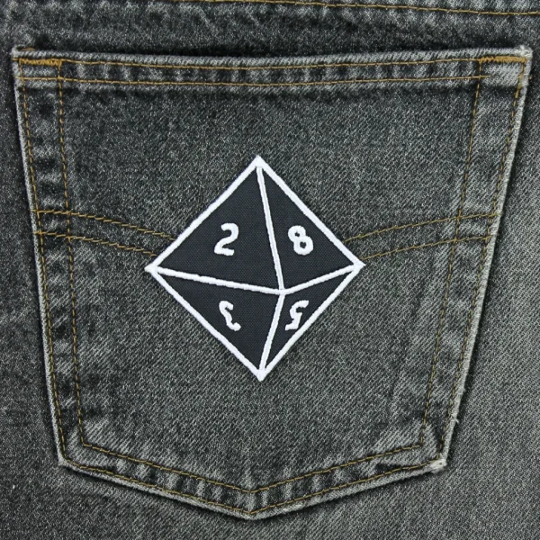 medium d8 Dice Embroidered Patch on black jeans