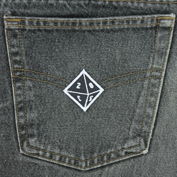 small d8 Dice Embroidered Patch on black jeans