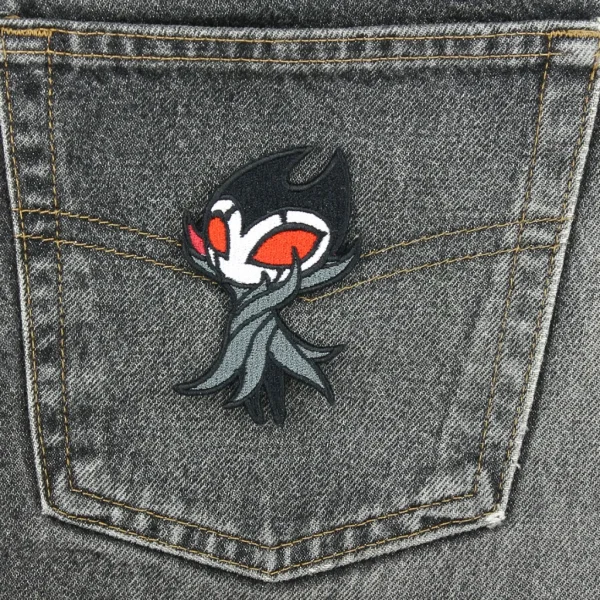 Hollow Knight Grimm Embroidered Patch on black jeans