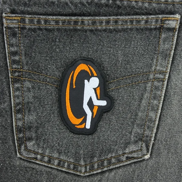 medium Orange Portal Embroidered Patch on black jeans