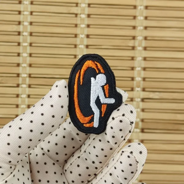 small Orange Portal Embroidered Patch on holding hand