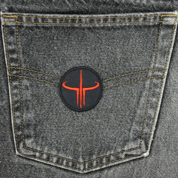 small Quake 3 Embroidered Patch on black jeans