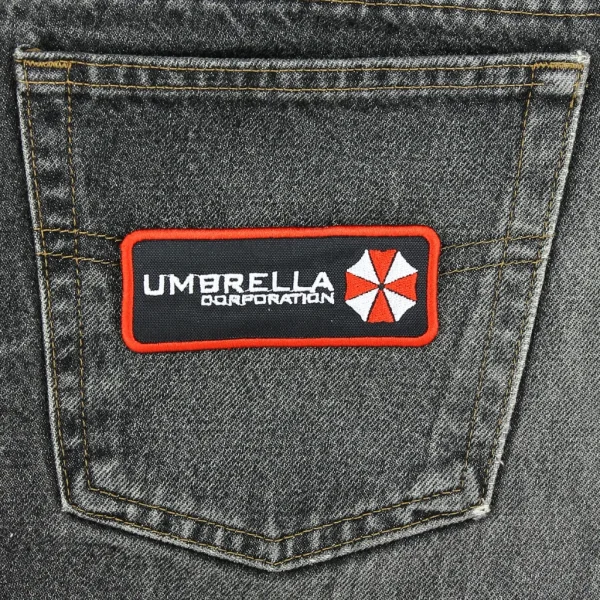 Umbrella Corporation Embroidered Patch on black jeans