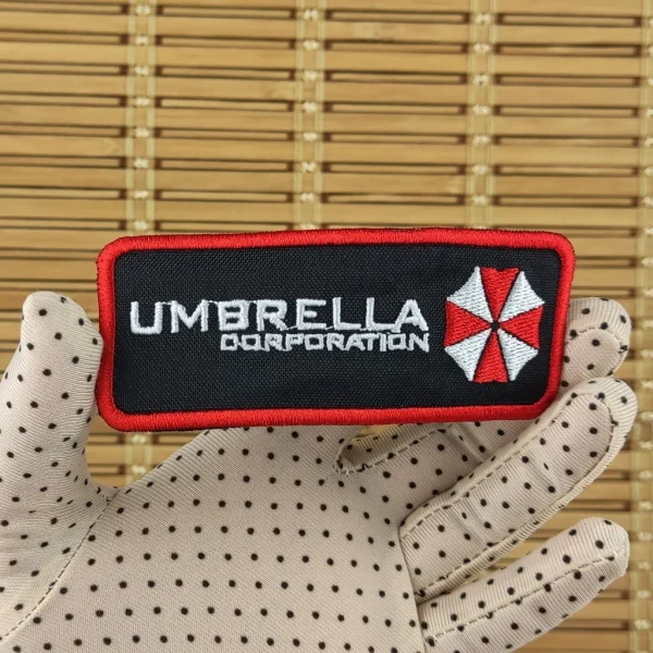 Umbrella Corporation Embroidered Patch on holding hand