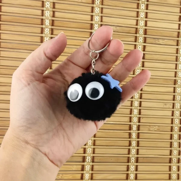 Pompom Spirit Keychain with blue star on holding hand