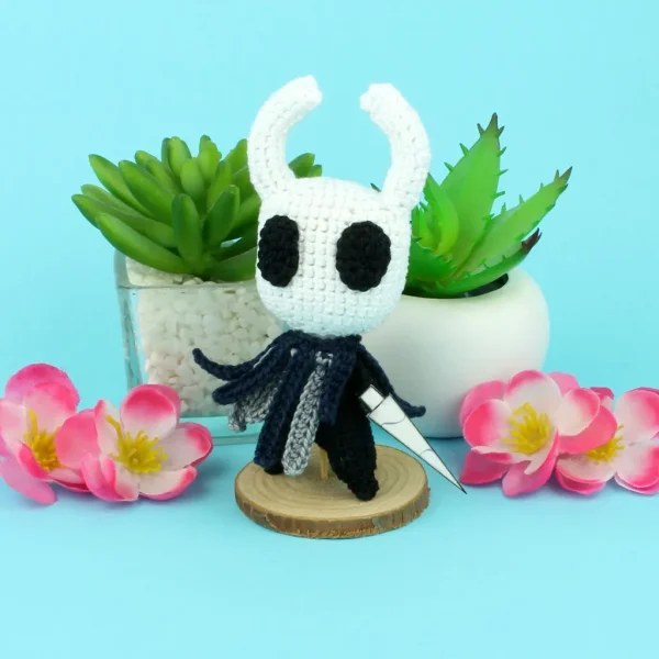 knight Crochet Amigurumi next to flowers