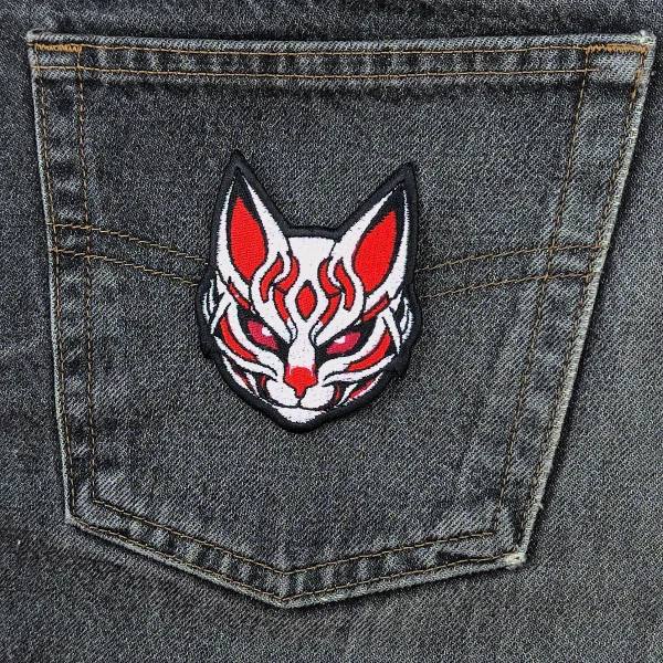 Kitsune Cat Mask Embroidered Patch in red and white colors on jeans