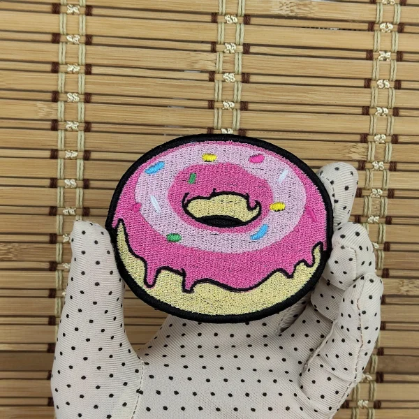 medium Pink Donut Embroidered Patch on holding hand