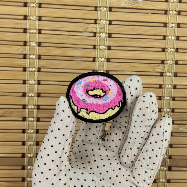 small Pink Donut Embroidered Patch on holding hand